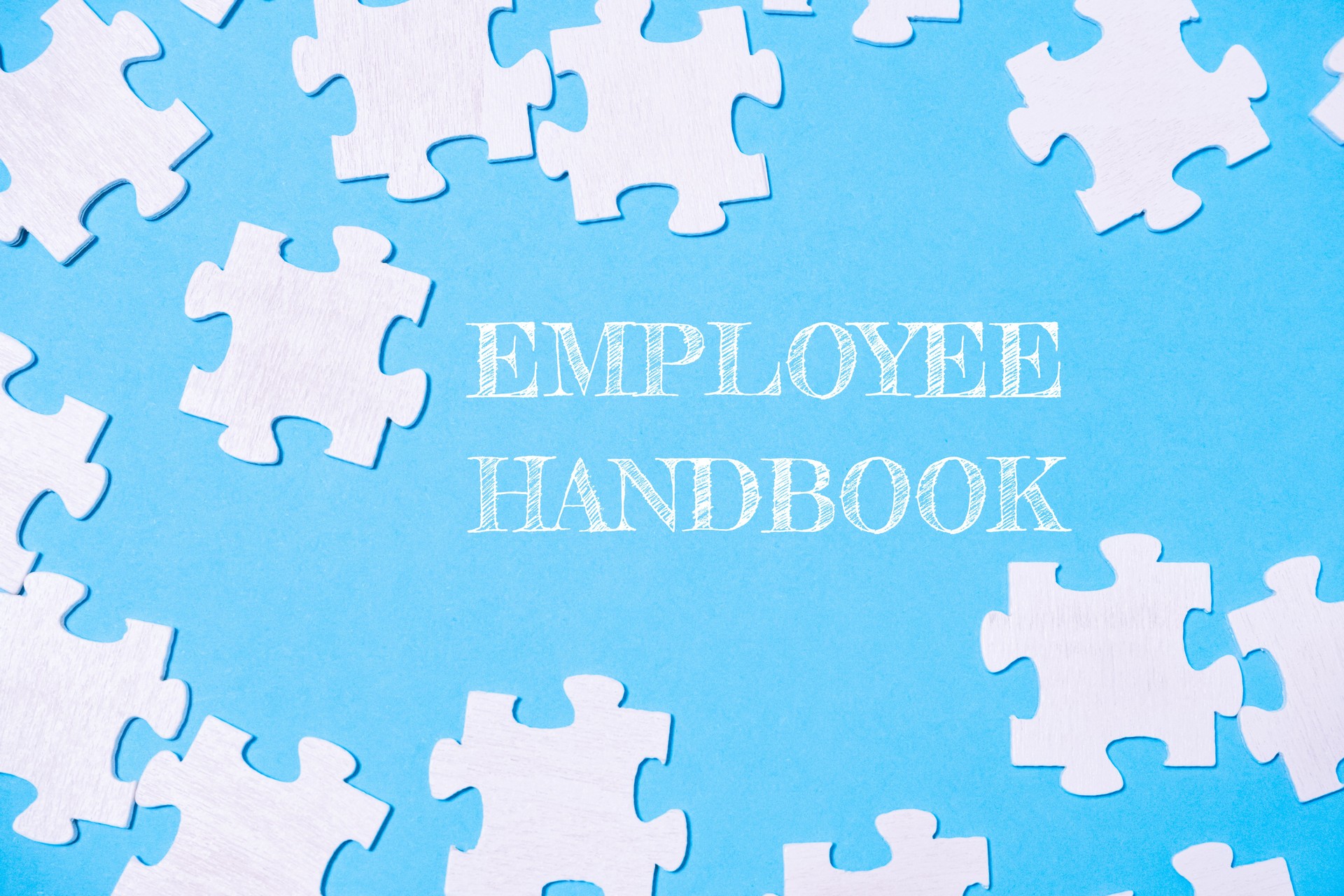 A jigsaw puzzle with the words Employee Handbook written